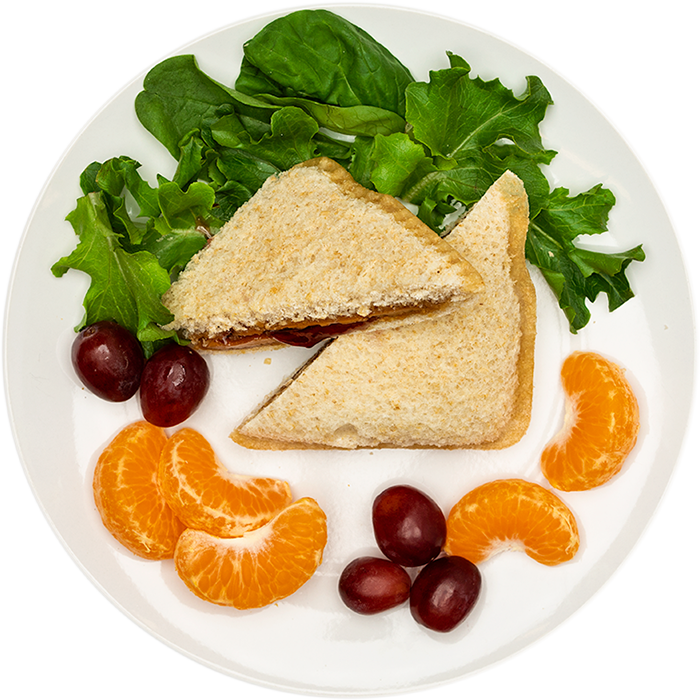 Image of the Wowbutter & Grape Jelly EZ Jammer crustless product on a plate, with other assorted foods