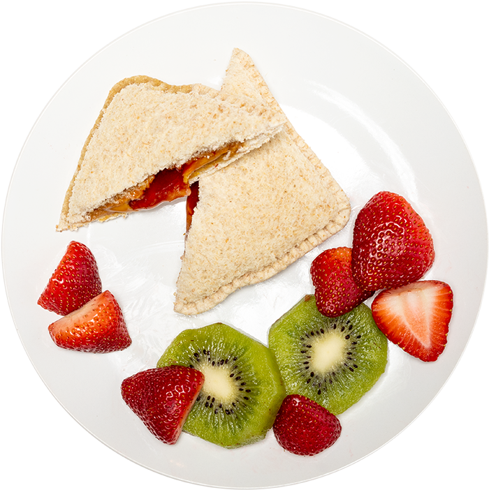 Image of the Wowbutter & Strawberry Jam EZ Jammer Crustless product on a plate, with other assorted foods