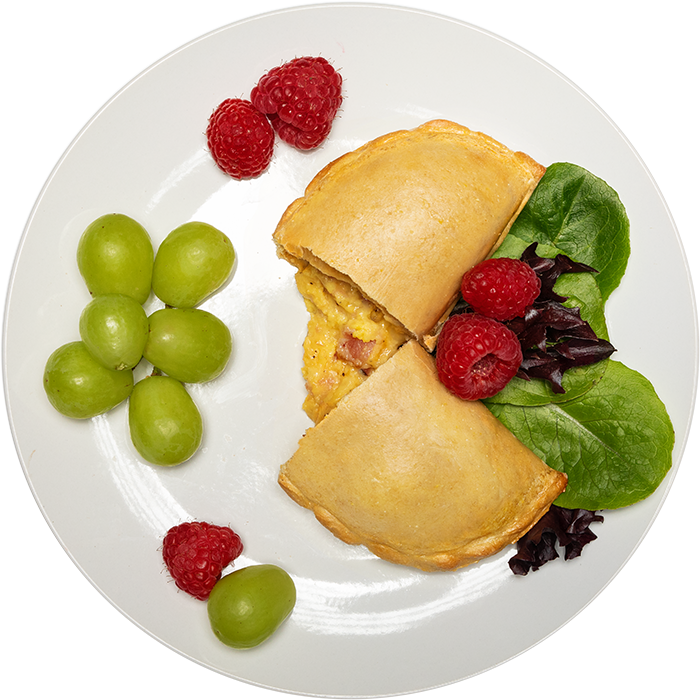 Image of the Bacon Breakfast pocket product on a plate, with other assorted foods