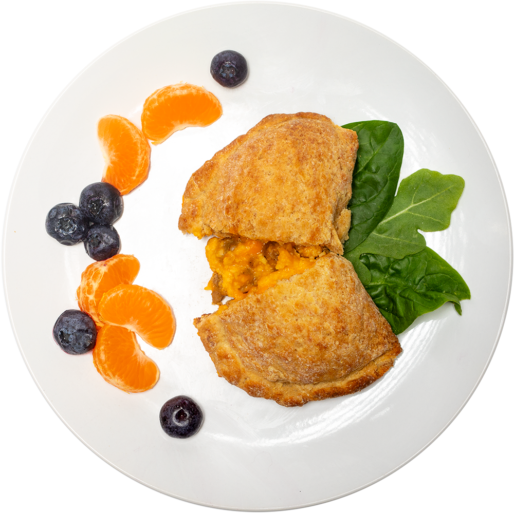 Image of the Sausage Biscuit Pocket product on a plate, with other assorted foods