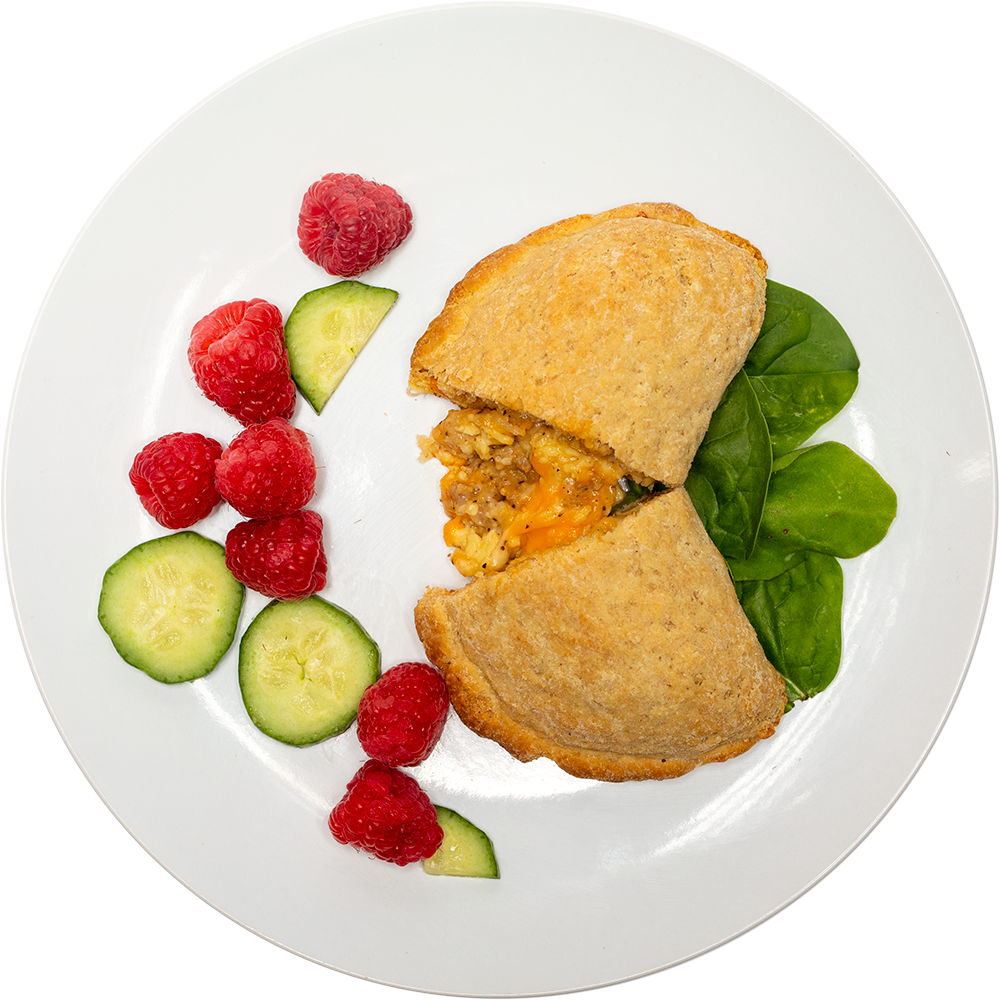 Image of the Turkey Sausage Biscuit Pocket product on a plate, with other assorted foods